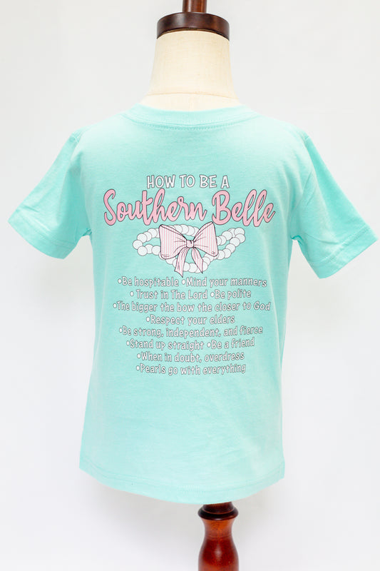 Mint green t-shirt with 'How to be a Southern Belle' text and graphics on a mannequin against a white background